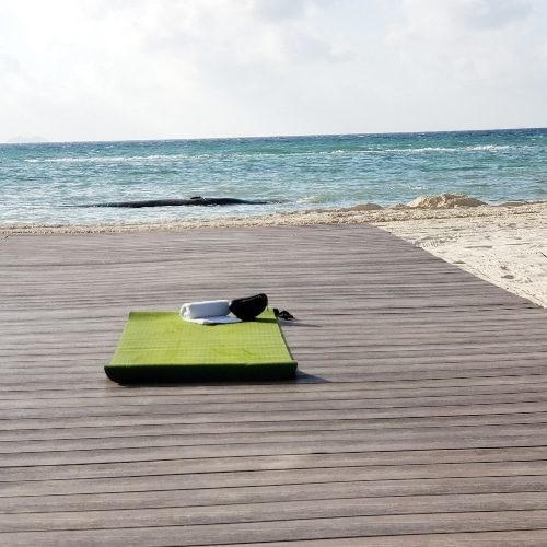 Yoga mat on pier at the beach