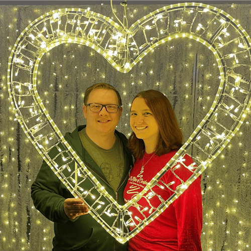 Jenny G and partner behind gold heart