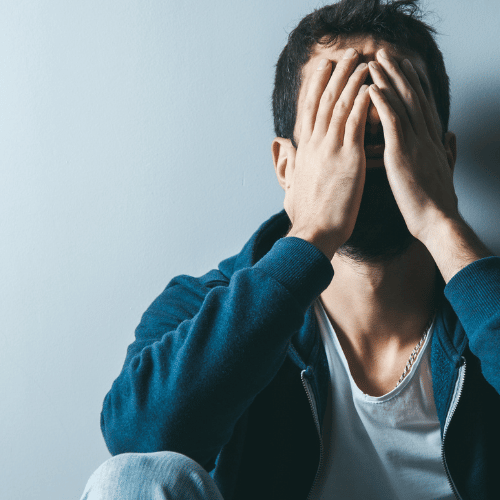 Man with hands over face